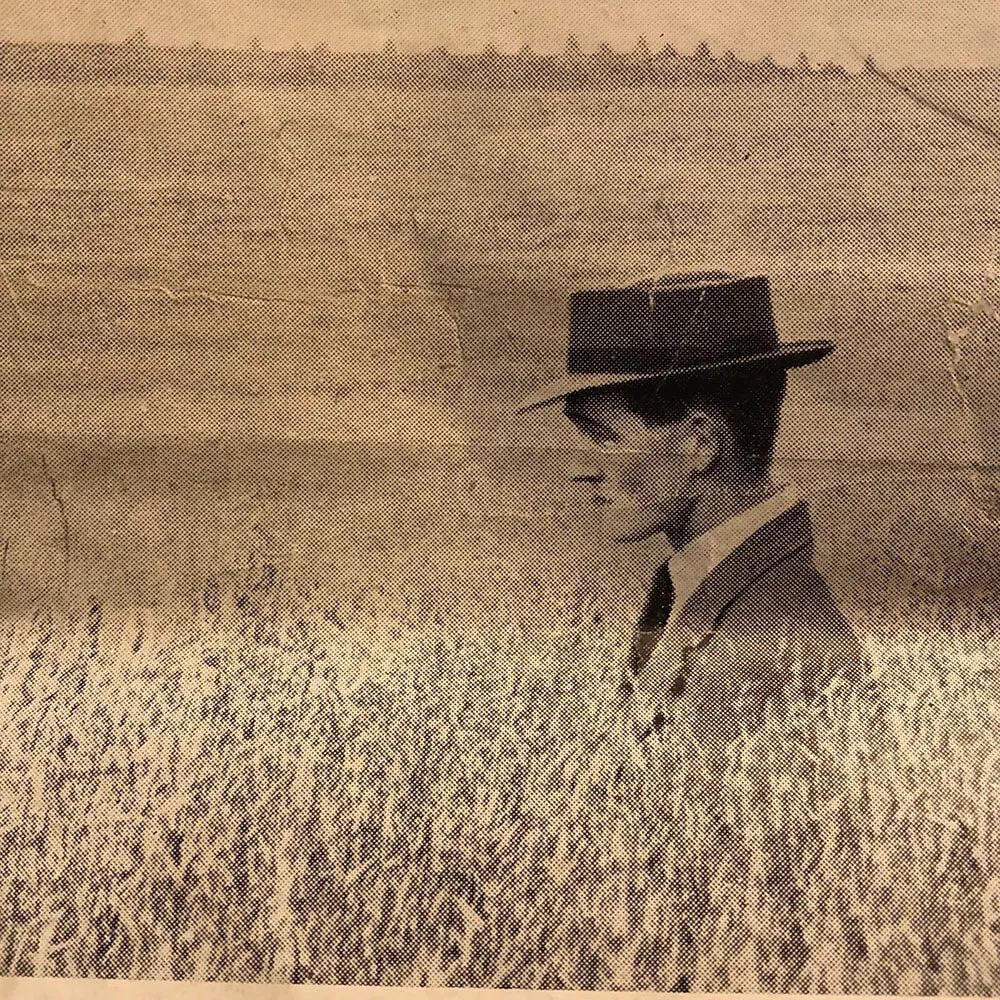 Logie farmer with hat on in field